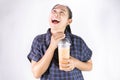 Happy Asian young woman is drinking Thai tea with milk. Popular beverage in Asia Royalty Free Stock Photo
