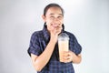 Happy Asian young woman is drinking Thai tea with milk. Popular beverage in Asia Royalty Free Stock Photo