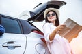 Happy Asian young woman enjoying a ride in a car, she is using a map for navigation. Royalty Free Stock Photo