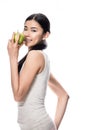 Happy Asian young woman holding a green apple Royalty Free Stock Photo