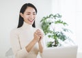 Happy asian young woman  making distance video call with congratulations gesture for chinese new year Royalty Free Stock Photo