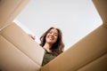 Happy Asian young woman opening carton box from internet store order shopping online Royalty Free Stock Photo