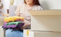 Happy asian young woman, packing stuff clothes, give second hand for donate