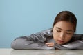 Head shot of cheerful happy asian young woman posing over blue background Isolated. Vertical portrait. Royalty Free Stock Photo