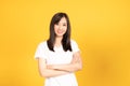 Happy asian young woman wearing white t-shirt standing with crossed arm