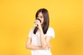 Happy asian young woman wearing white t-shirt standing and holding a coffee