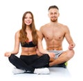 Happy athletic couple practicing yoga, doing exercise for relaxa