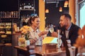 Happy attractive African-American couple in love having a great time together in a restaurant at their dating. A Royalty Free Stock Photo