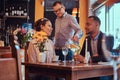 Happy attractive African-American couple in love having a great time together in a restaurant at their dating. A Royalty Free Stock Photo