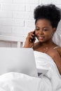 Happy attractive african american girl working office work remotely, Black woman using laptop computer and phone sitting Royalty Free Stock Photo