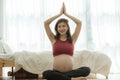 Happy Attractive Asian Pregnant woman practice yoga lotus pose to meditation smile with big belly after wake up in the morning Fee Royalty Free Stock Photo