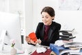 Happy attractive businesswoman opening heart shaped red present box Royalty Free Stock Photo