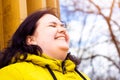 Happy attractive chubby overweight Caucasian woman smiling portrait outdoors. Cheerful pretty body positive person laughing