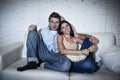 Happy attractive couple having fun at home enjoying watching television relaxed Royalty Free Stock Photo
