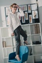 happy attractive fashion designer standing on chair Royalty Free Stock Photo