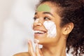 Lovely charming young woman taking care of her facical skin. Cosmetics and beauty concep