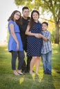 Happy Attractive Hispanic Family With Their Pregnant Mother Outdoors Royalty Free Stock Photo