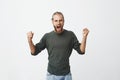 Happy attractive man with beard screaming loudly and expressive gesticulating with hands when his favourite football Royalty Free Stock Photo