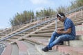 Happy attractive man listening music and typing phone Royalty Free Stock Photo