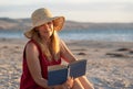 Woman in red with arms outstretched by the sea at sunrise enjoying freedom and outdoors life Royalty Free Stock Photo