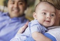 Happy Attractive Mixed Race Couple Burping Thier Son Royalty Free Stock Photo