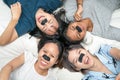 Happy attractive young women with pore strip, lying on bed. Top view shot