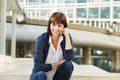 Happy attractive older woman sitting outside in city Royalty Free Stock Photo