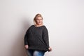 A happy attractive overweight woman in studio on a white background.