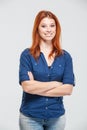 Happy attractive redhead young woman standing with arms crossed Royalty Free Stock Photo