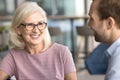 Happy attractive senior businesswoman talking to younger colleague man Royalty Free Stock Photo