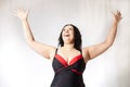 Happy attractive thick woman in swimsuit posing on white background. Body positive, photoshoot, selfie. Funny plus size