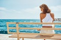 Happy woman on the bench during summer vacation