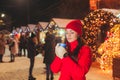 Happy attractive woman dreaming with cup of tea, Christmas market Royalty Free Stock Photo