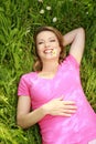 Happy attractive woman laying in the grass smiling Royalty Free Stock Photo