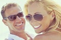 Happy Attractive Woman and Man Couple In Sunglasses At Beach Royalty Free Stock Photo