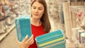 Happy attractive woman in red t-shirt shopping in mall buying basket. Consumerism shopaholism concept