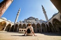 Happy attractive woman tourist in hat, posing in courtyard of Suleymaniye mosque, Istanbul, Turkey. Religion and travel concept Royalty Free Stock Photo