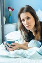 Happy attractive woman wake up in the morning in bed with cup of coffee Royalty Free Stock Photo