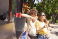 Happy attractive young couple romantically eating a fresh pizza outdoors. Royalty Free Stock Photo