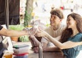 Happy attractive young couple romantically eating a fresh pizza outdoors. Royalty Free Stock Photo