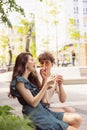 Happy attractive young couple romantically eating a fresh pizza outdoors. Royalty Free Stock Photo