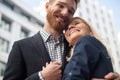 Happy attractive young couple to share a good joke, laughing loudly, embracing each other outdoors in urban environment. Royalty Free Stock Photo