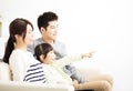 Happy Attractive Young Family watching the tv