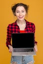 Happy attractive young woman holding blank screen laptop Royalty Free Stock Photo