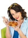 Happy Attractive Young Woman Holding a Plate of Spaghetti Meatballs Royalty Free Stock Photo
