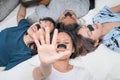 Happy attractive young women with pore strip, lying on bed. Top view shot