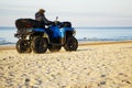 Happy ATV driver on the beach. Active recreation. Royalty Free Stock Photo