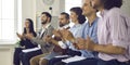 Happy audience applauding a speaker in a business conference or corporate meeting Royalty Free Stock Photo