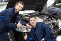 Happy auto mechanics. Royalty Free Stock Photo