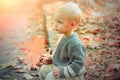 Happy autumn sunny day. Small baby toddler on sunny autumn day. Warmth and coziness. Happy childhood. Sweet childhood Royalty Free Stock Photo